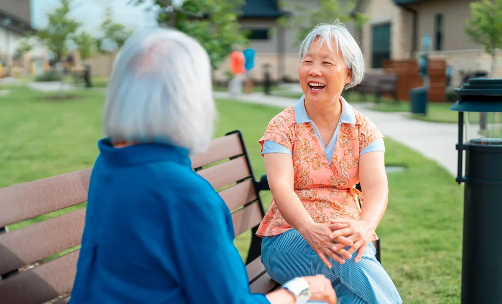 Outlook residents sitting on a bench in the grove
