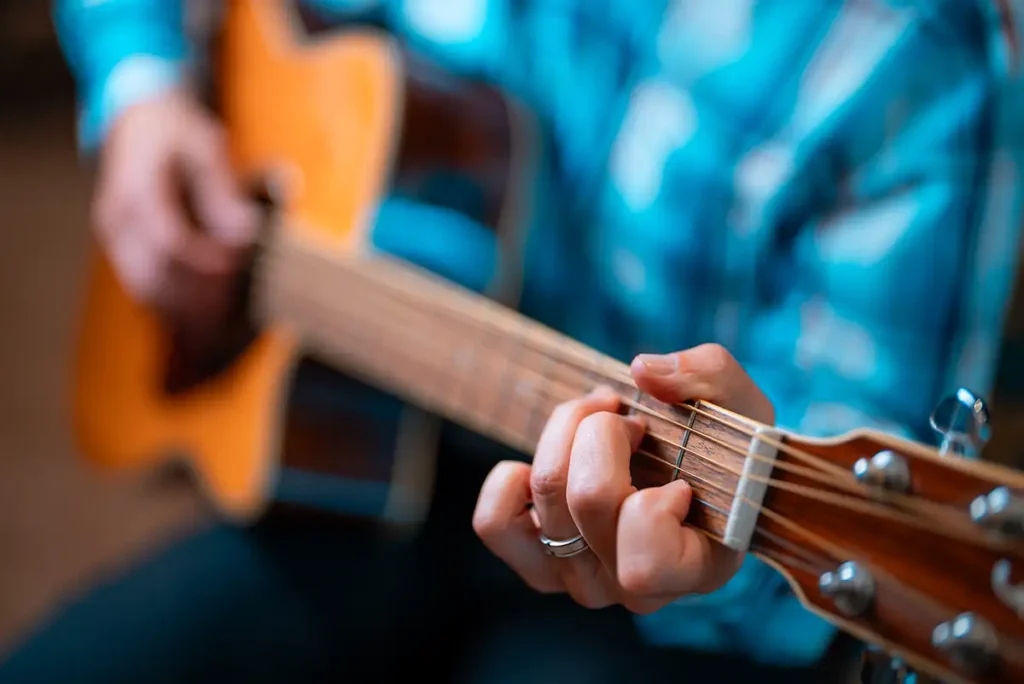 Outlook staff member playing guitar
